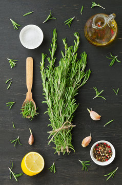 Bunch of rosemary with garlic, olive oil and spices