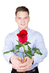 Young man giving ared rose