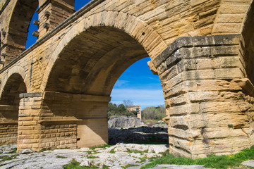 Pont du Gard, aqueduct in the world heritage, view under an arc of the bridge