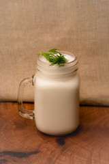 A glass of traditional Turkish cold drink ayran made of yoghurt on vintage background 