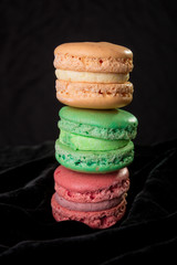 Macaroons on black velvet background. Isolated. French dessert