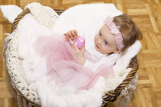 baby holding an egg for Easter