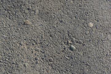 Abstract background of closeup dark uneven asphalt