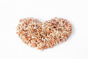 brown rice in heart shape isolated on white background