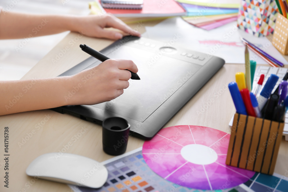 Sticker Designer workplace. Woman using graphic tablet, closeup