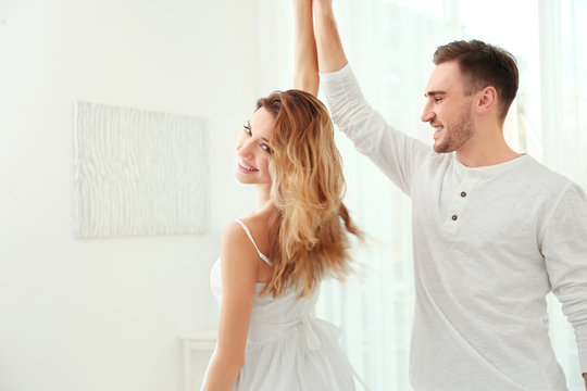 Cute Young Couple Dancing At Home