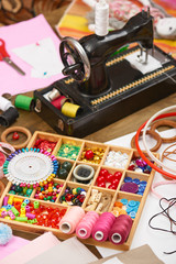 sewing machine and set of accessories to embroidery, haberdashery, sewing accessories top view, seamstress workplace, many object for needlework, handmade and handicraft