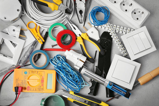 Electrician tools on grey background
