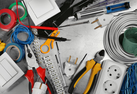 Electrician tools on metal background