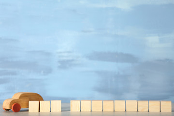 Cubes with space for text and wooden toy car on light background