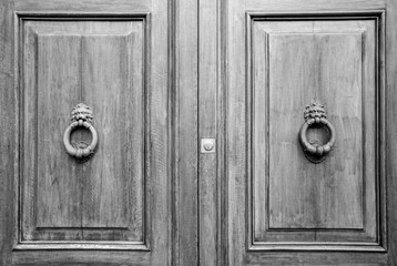 Details of an ancient Italian door, black and white.