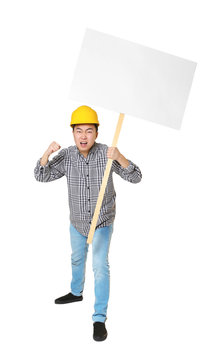 Protesting young Asian man holding placard with space for text on light background