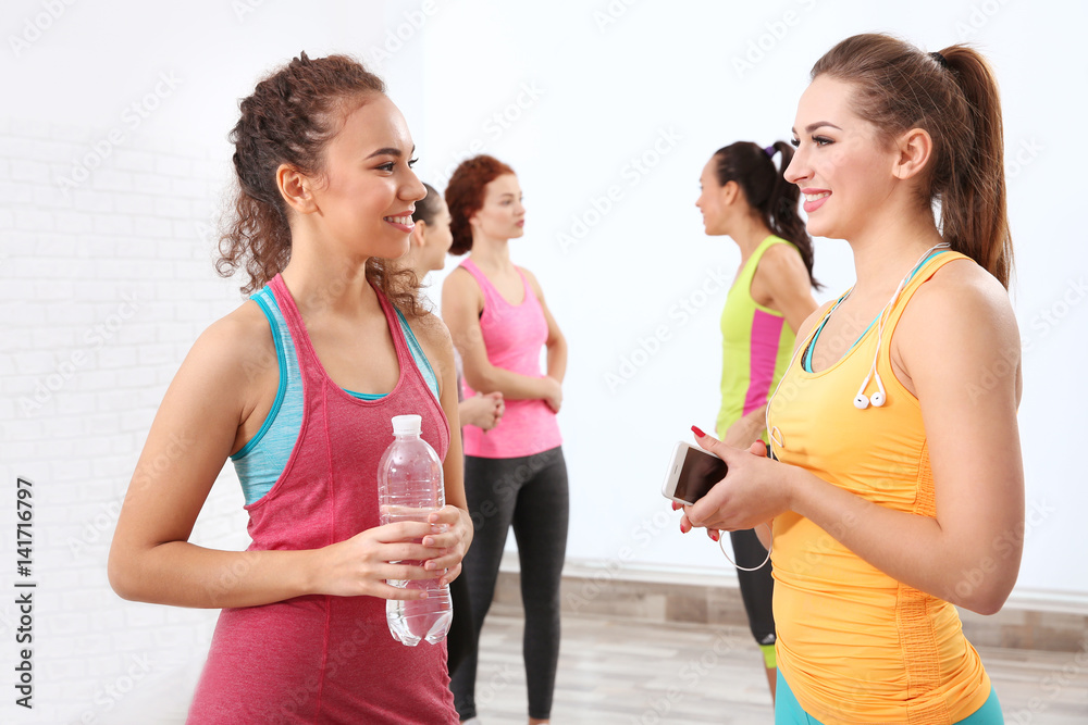 Poster beautiful girls chatting in gym