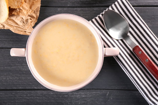 Delicious cream soup in pan on table