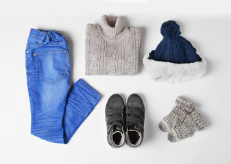 Baby clothes and accessories on white background