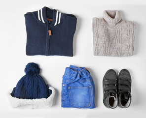 Baby clothes and accessories on white background