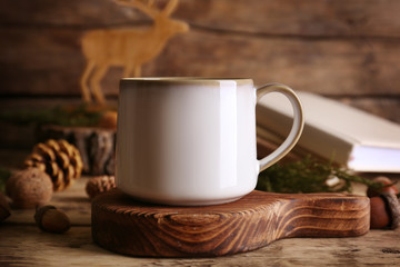 Blank ceramic cup on wooden stand