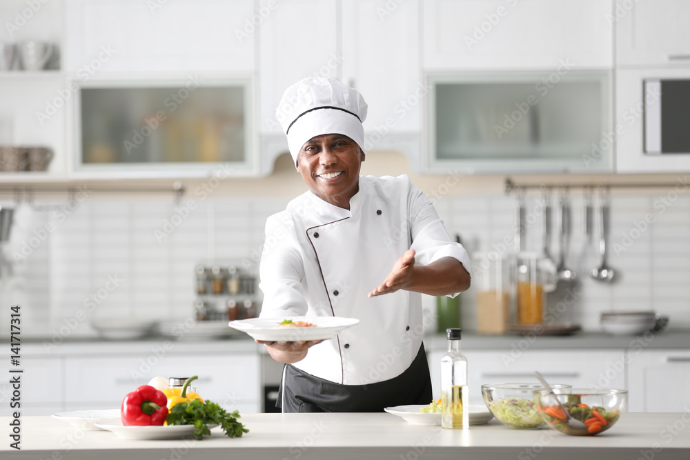 Sticker mature indian chef cooking in kitchen