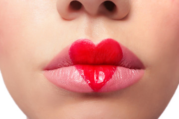 Beautiful woman with heart painted on lips, closeup