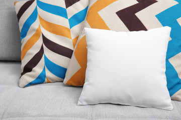 Blank soft pillow on cozy couch
