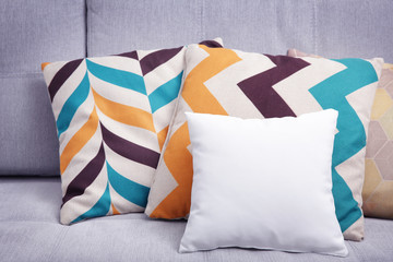 Blank soft pillow on cozy couch
