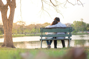 couple sitting on bench in the garden