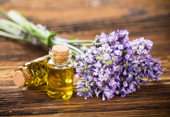Wellness treatments with lavender flowers on wooden table.