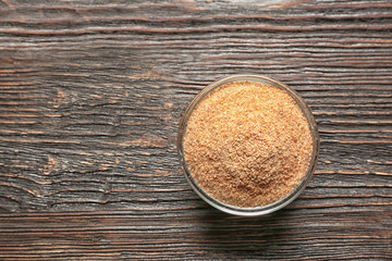 Glass bowl with bread crumbs on wooden table