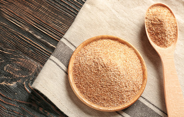 Bowl and spoon with bread crumbs on napkin