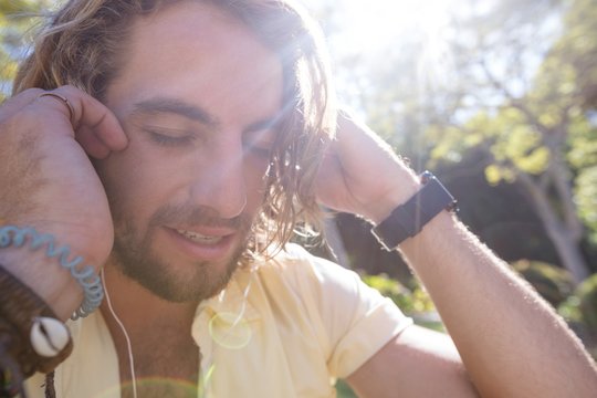 Close-up of man listening to music with earphone