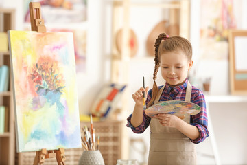 Cute little artist in studio