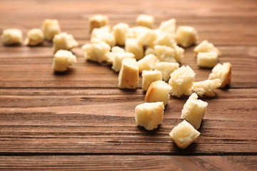 Croutons of wheaten bread on wooden background