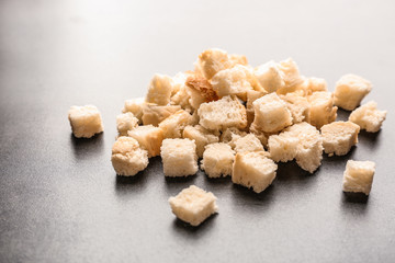 Croutons of wheaten bread on grey background