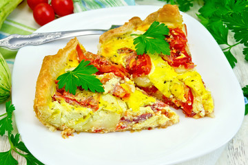Flan with tomato and zucchini in plate on napkin