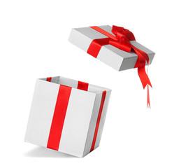 Open gift box with red ribbon on white background