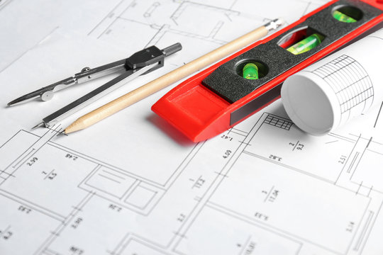 Different kinds of engineering tools on construction drawings background