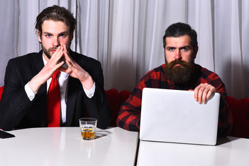 bearded men, businessmen with glass of whiskey, laptop and phone