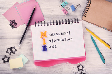 Notebooks and stationery on wooden table. Management concept © Africa Studio