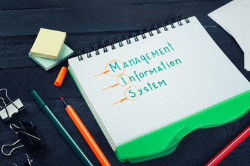 Notebook and stationery on dark wooden table. Management concept