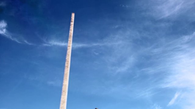 passing column on the background of blue sky