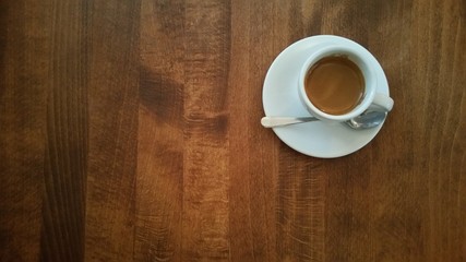 Cup of coffe on brown table