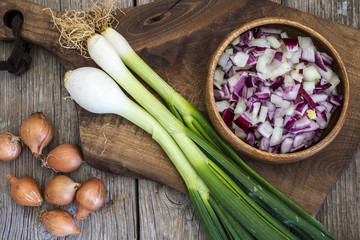 Raw onions on wooden table