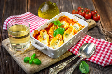 Stuffed pasta shells casserole with gorgonzola, ricotta and tomato sauce