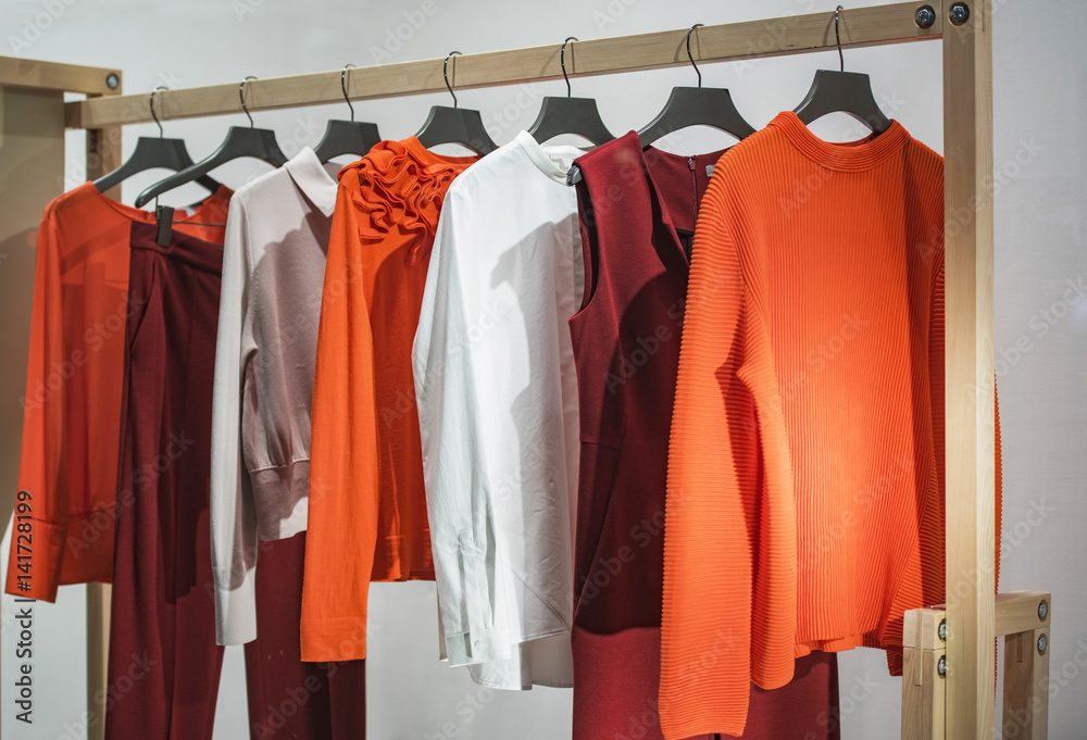 Wall mural Women clothes on racks in a store in London.