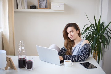 Young business girl in her personal workspace working