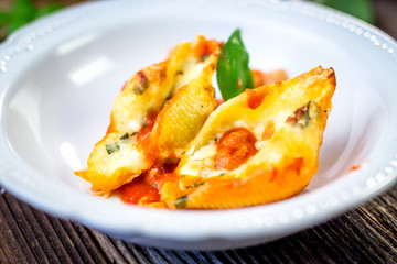 Stuffed pasta shells casserole with gorgonzola, ricotta and tomato sauce