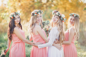 Beautiful bride hugging bridesmaids.