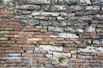  Old multi colored brick and stone wall.