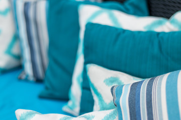 Colorful pillows on a blue sofa. White, blue, dark blue.