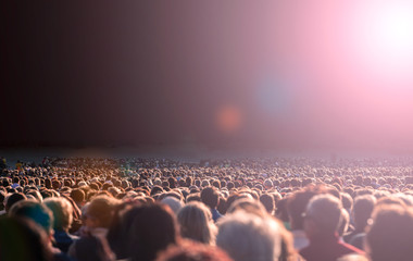 Fototapeta na wymiar Panoramic photo of large crowd of people. Slow shutter speed motion blur.